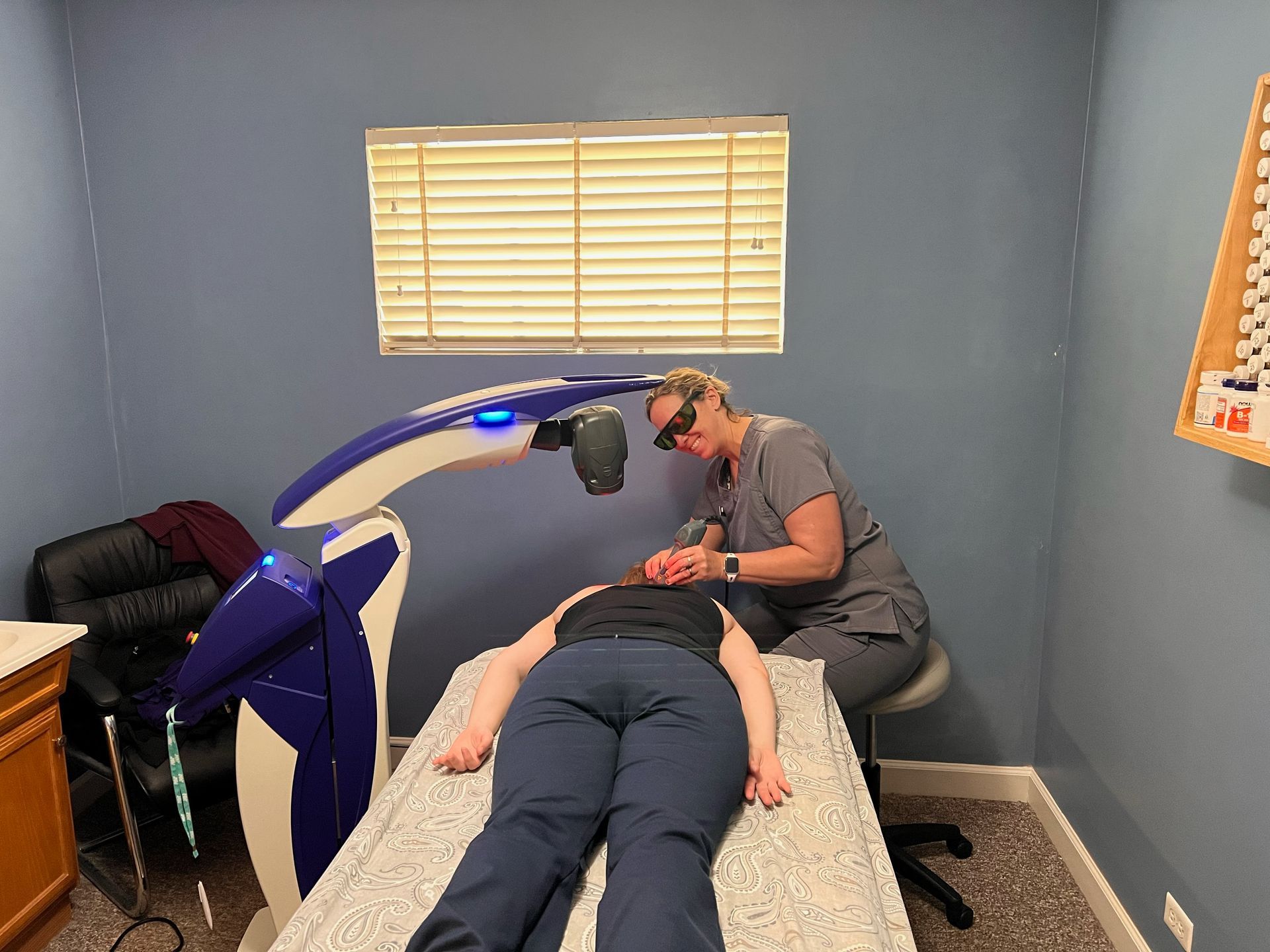 Dr. Vicki treating a patient with the MLS Laser