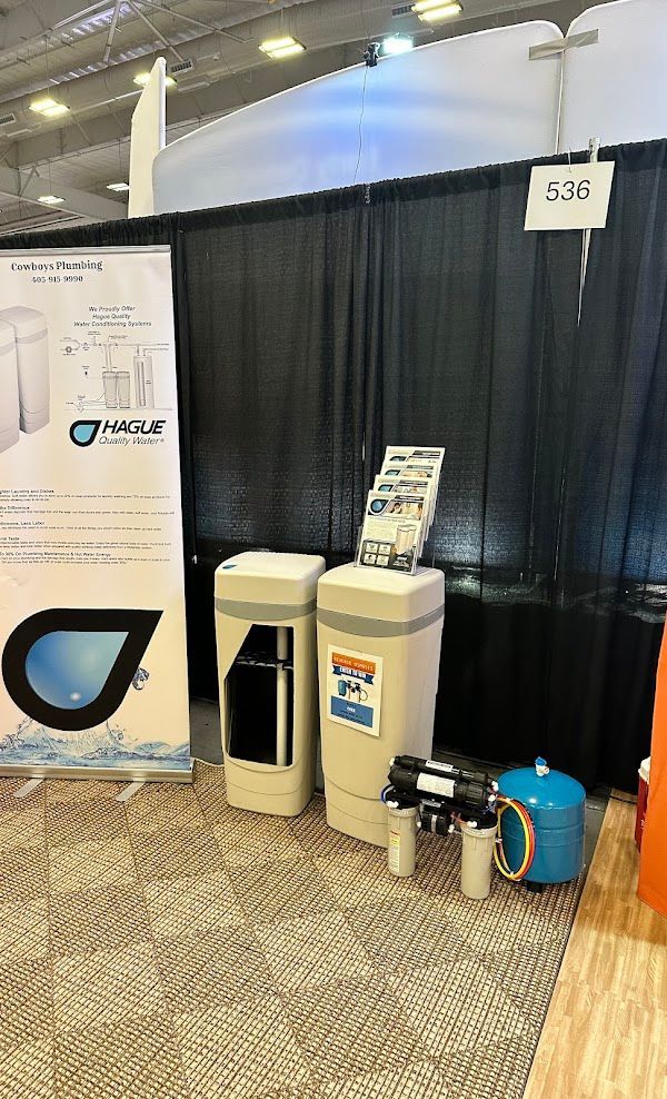 Cowboys Plumbing - Water filtration systems on display at a trade show booth.