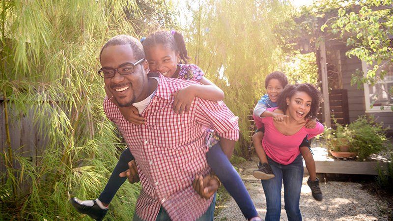 family holding kids on their backs