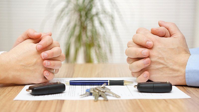 folded hands on contract