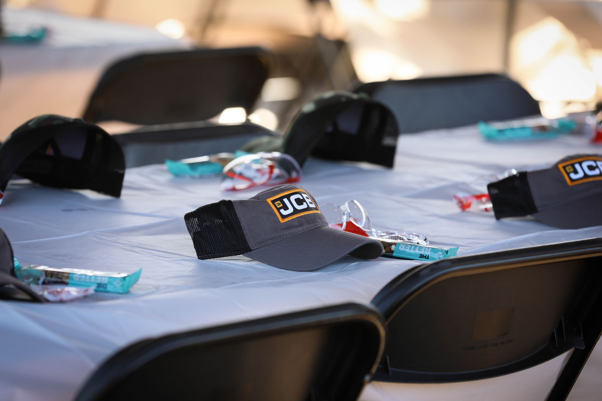 A table with a hat that says jcb on it