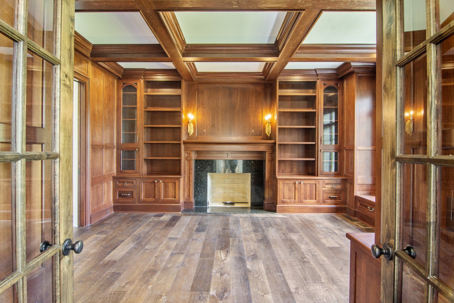 An empty room with a fireplace and shelves