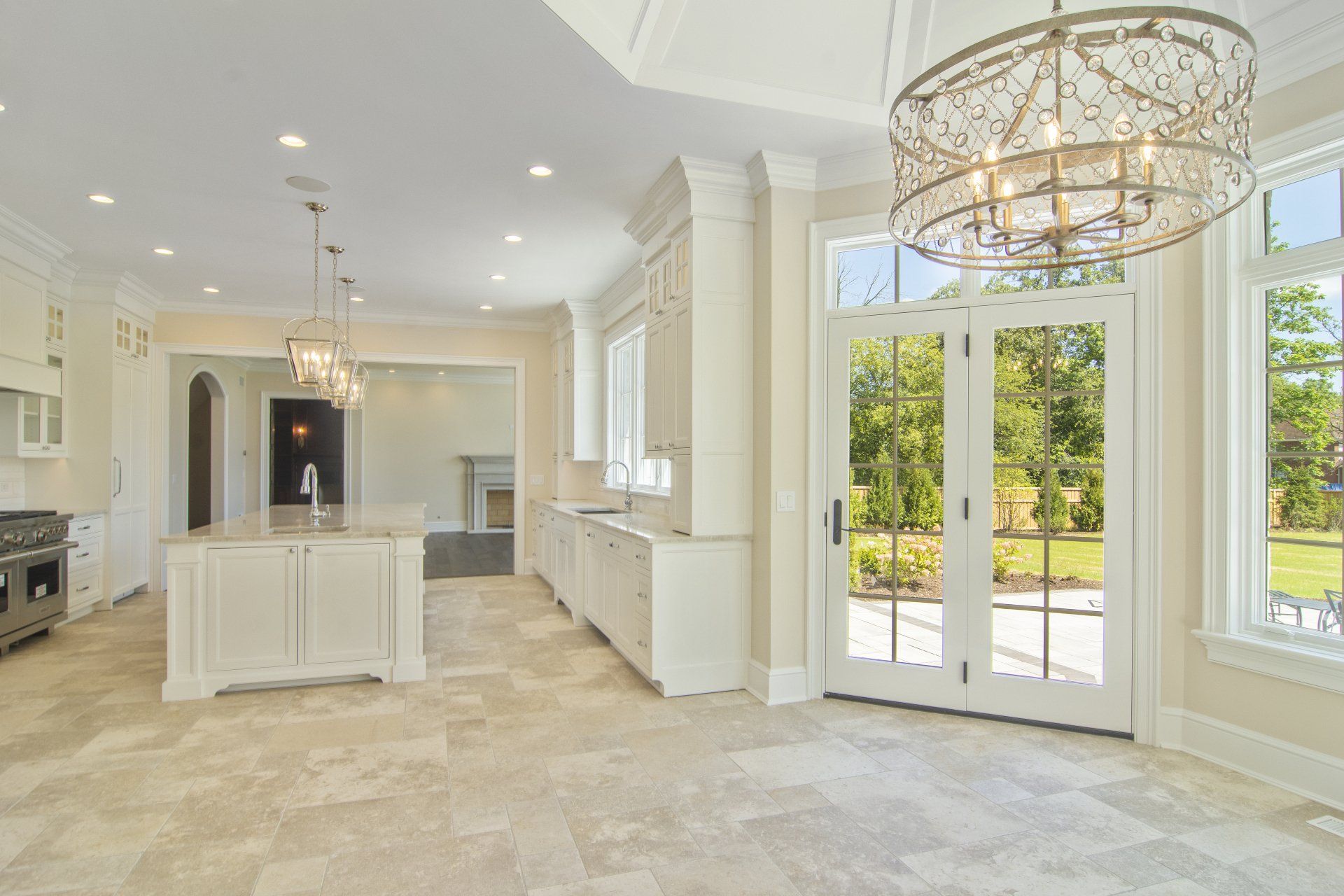 A kitchen with a lot of windows and a chandelier hanging from the ceiling.