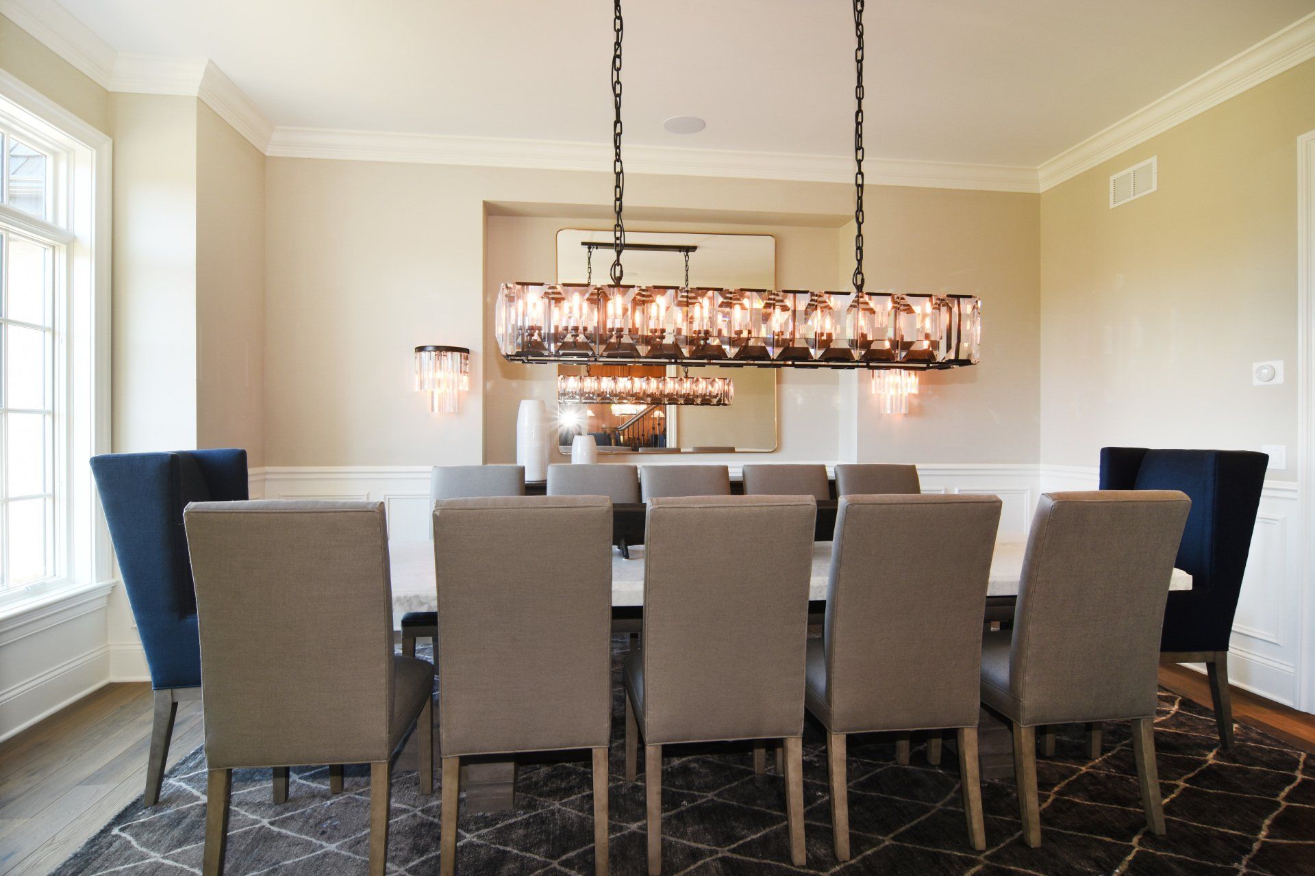 A dining room with a long table and chairs
