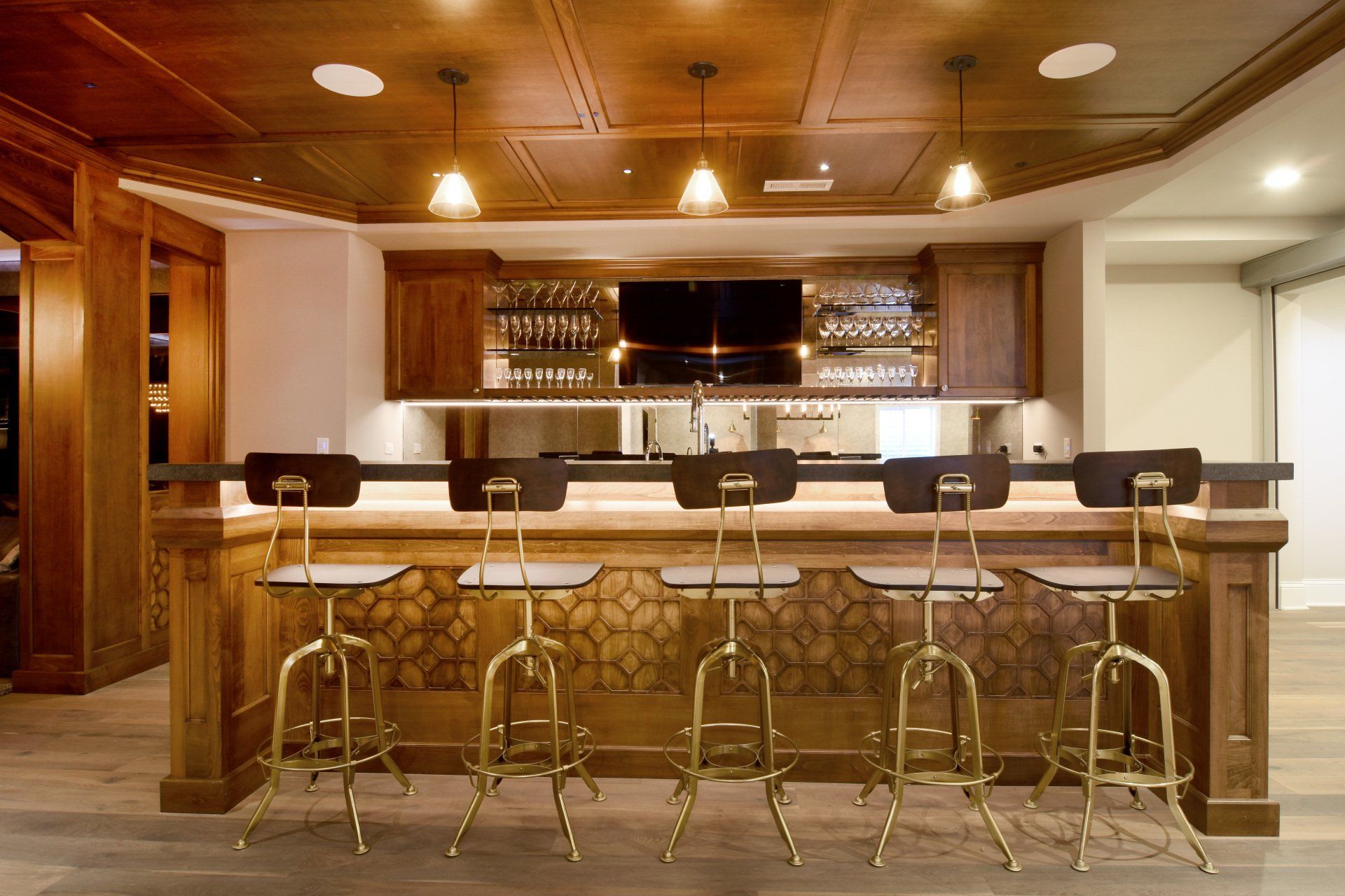 A kitchen with a bar and stools in it