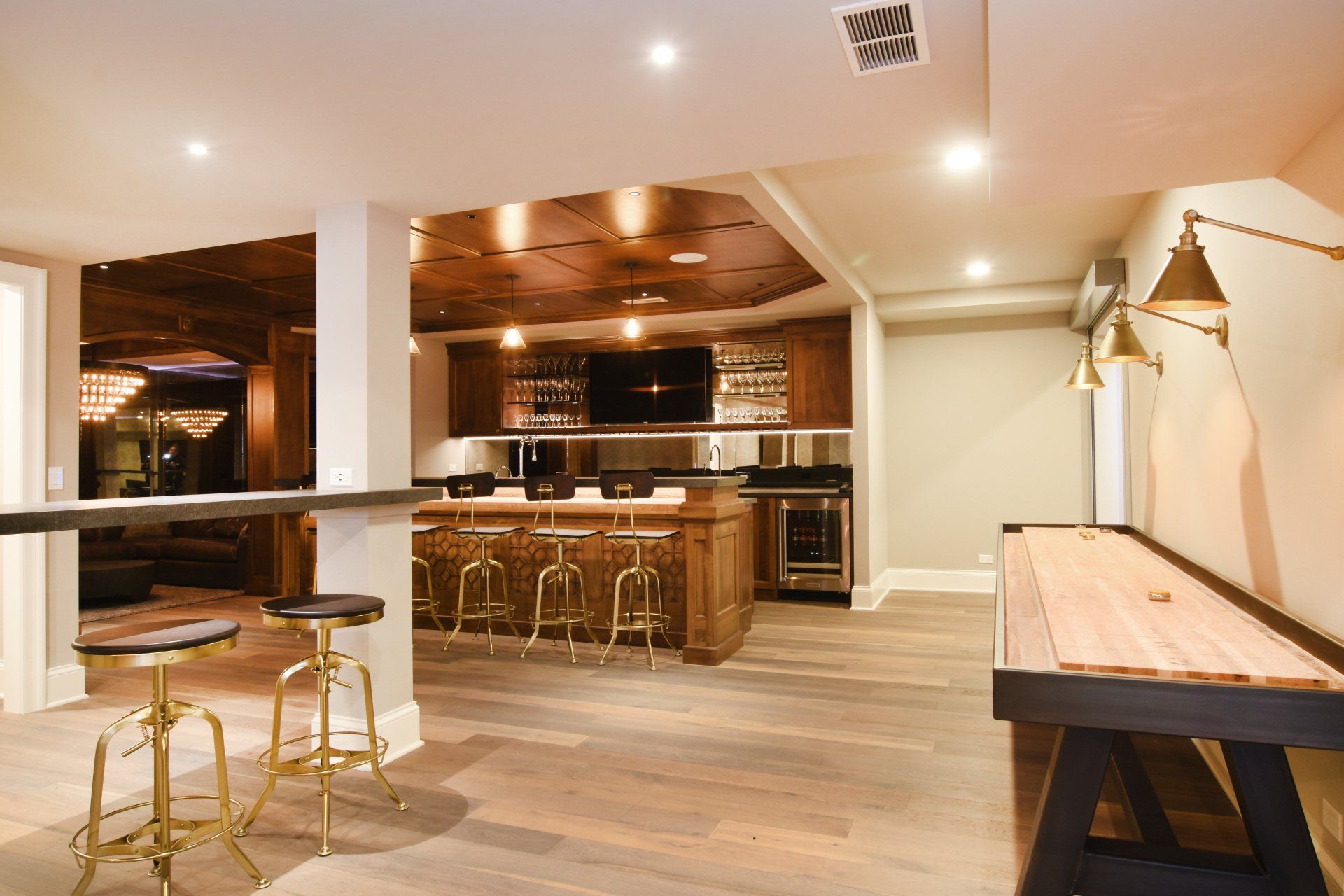There is a shuffleboard table in the middle of the room.