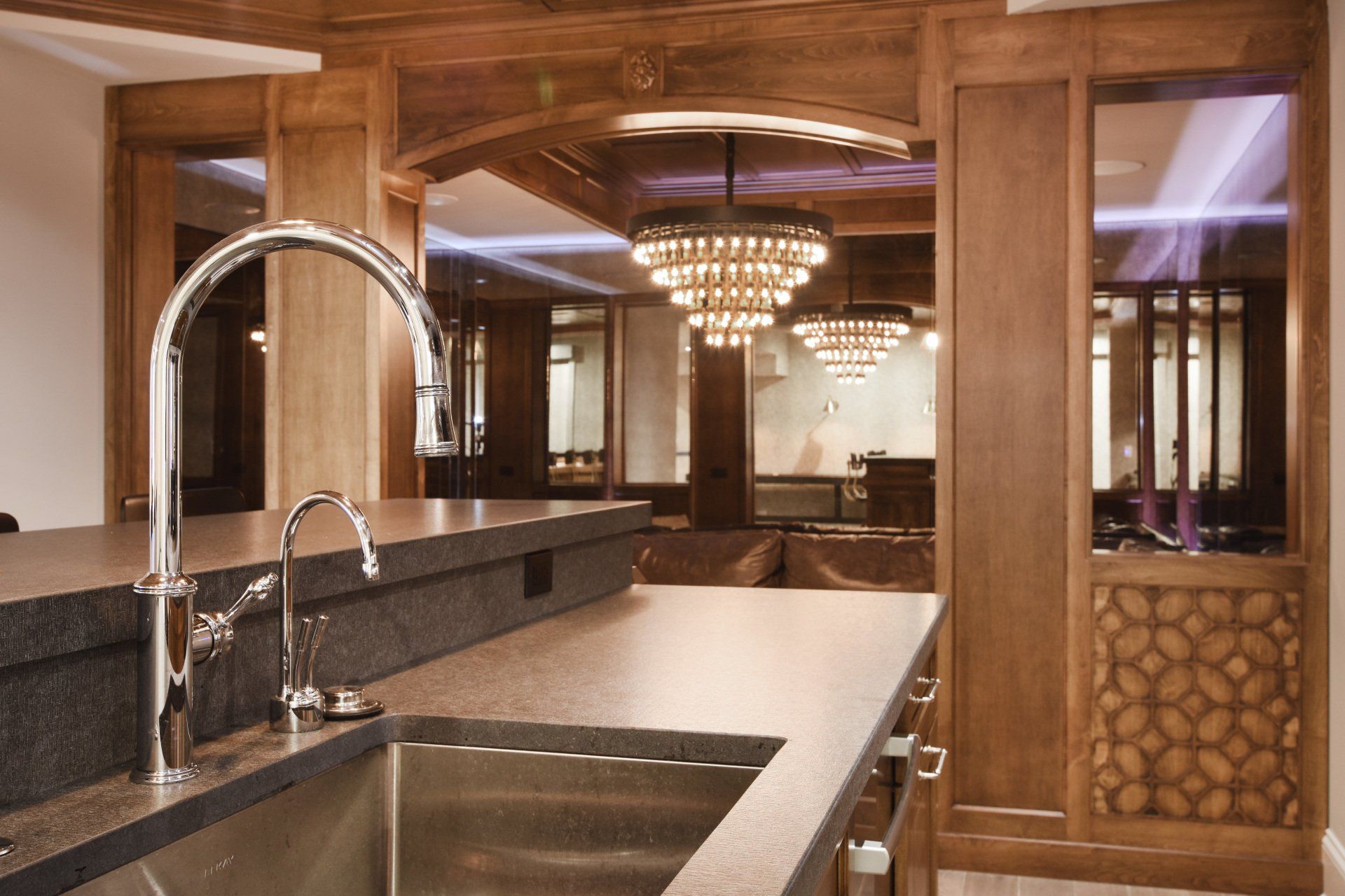 A kitchen with a stainless steel sink and a faucet