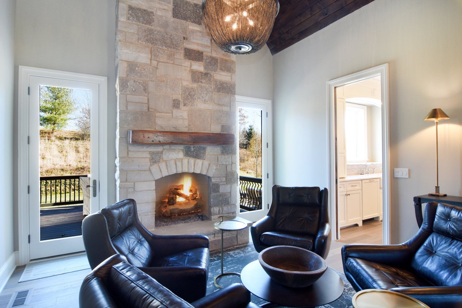 A living room with a fireplace and chairs