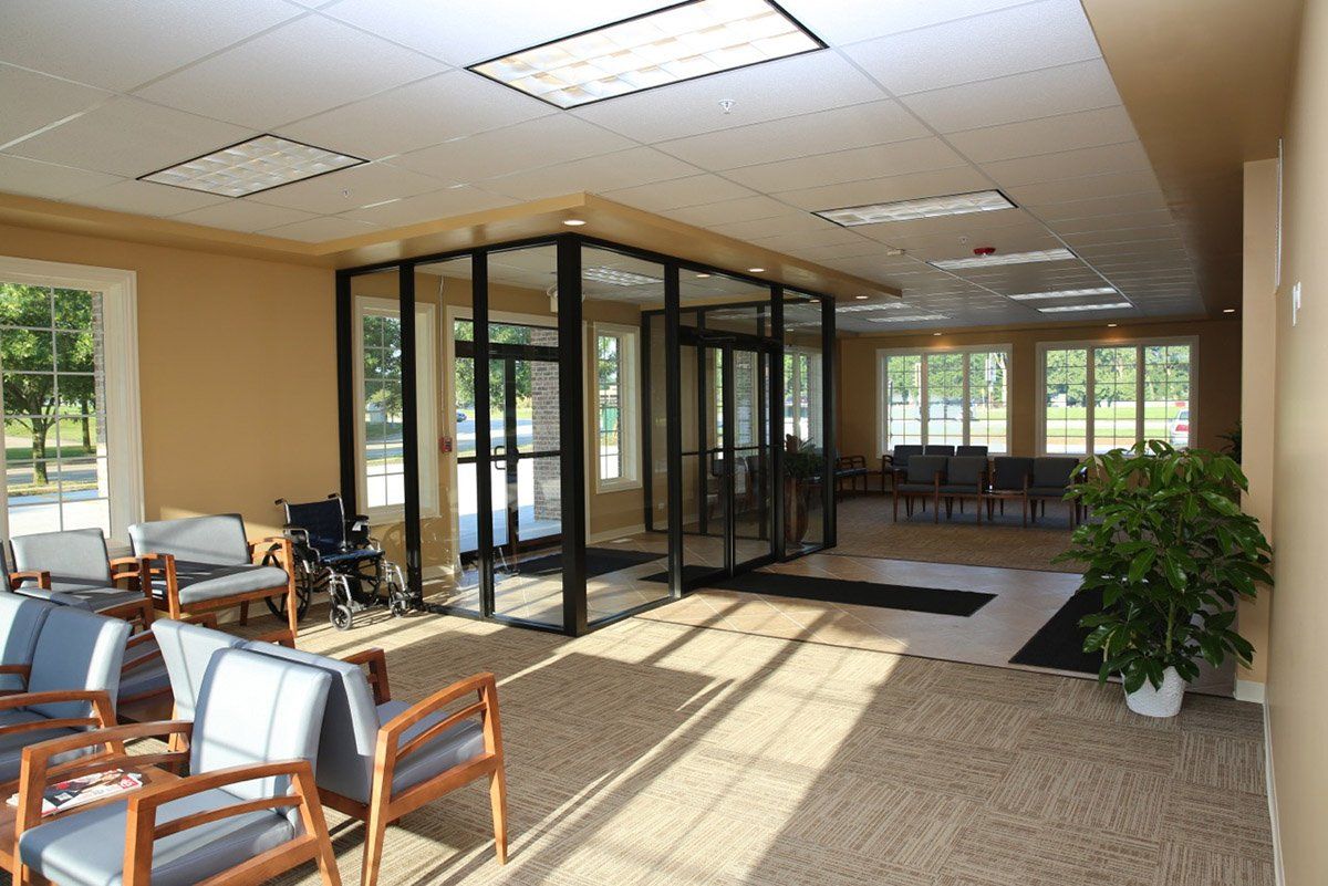 A waiting room with chairs and a wheelchair in it