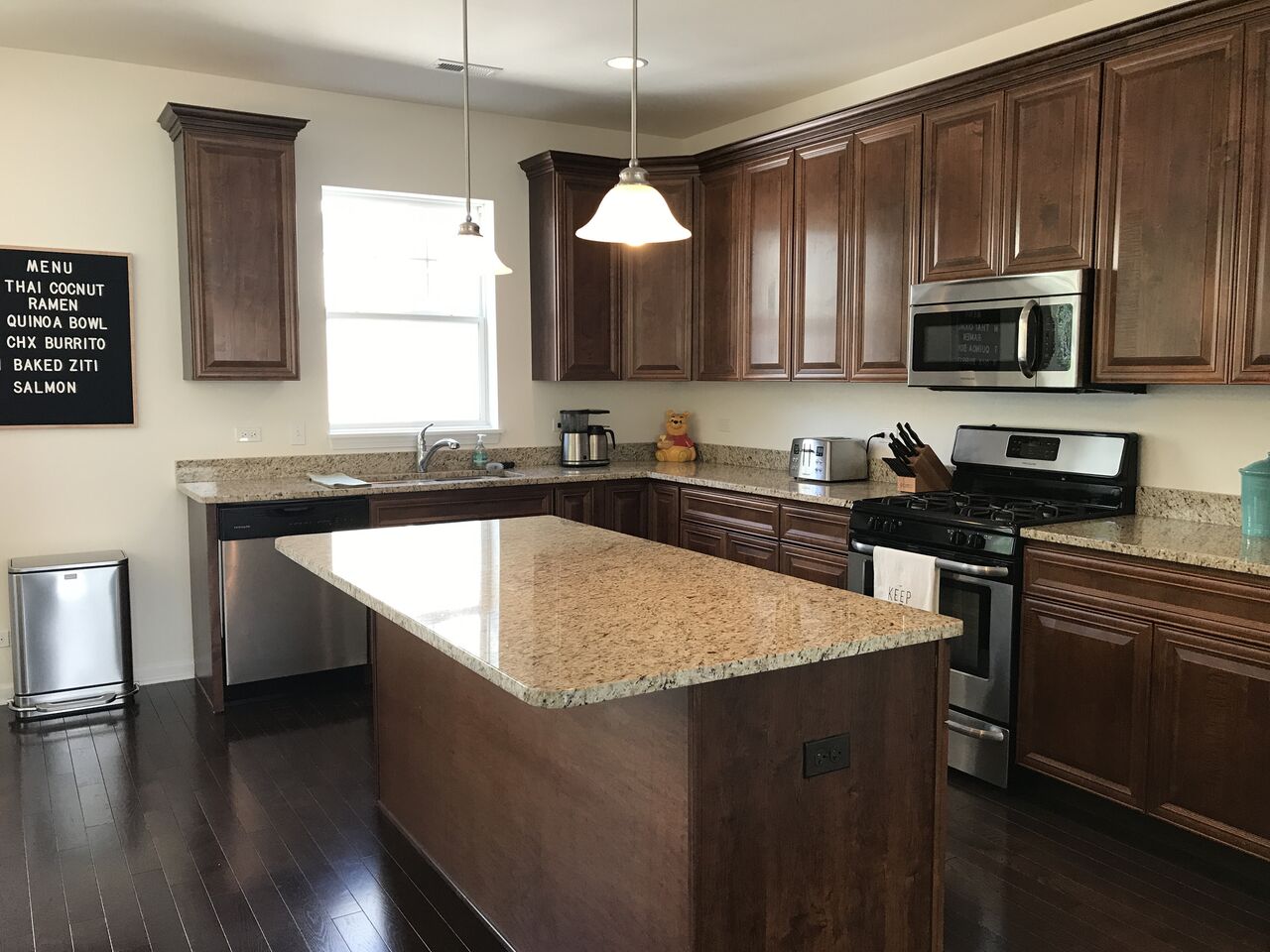 A kitchen with a large island and stainless steel appliances