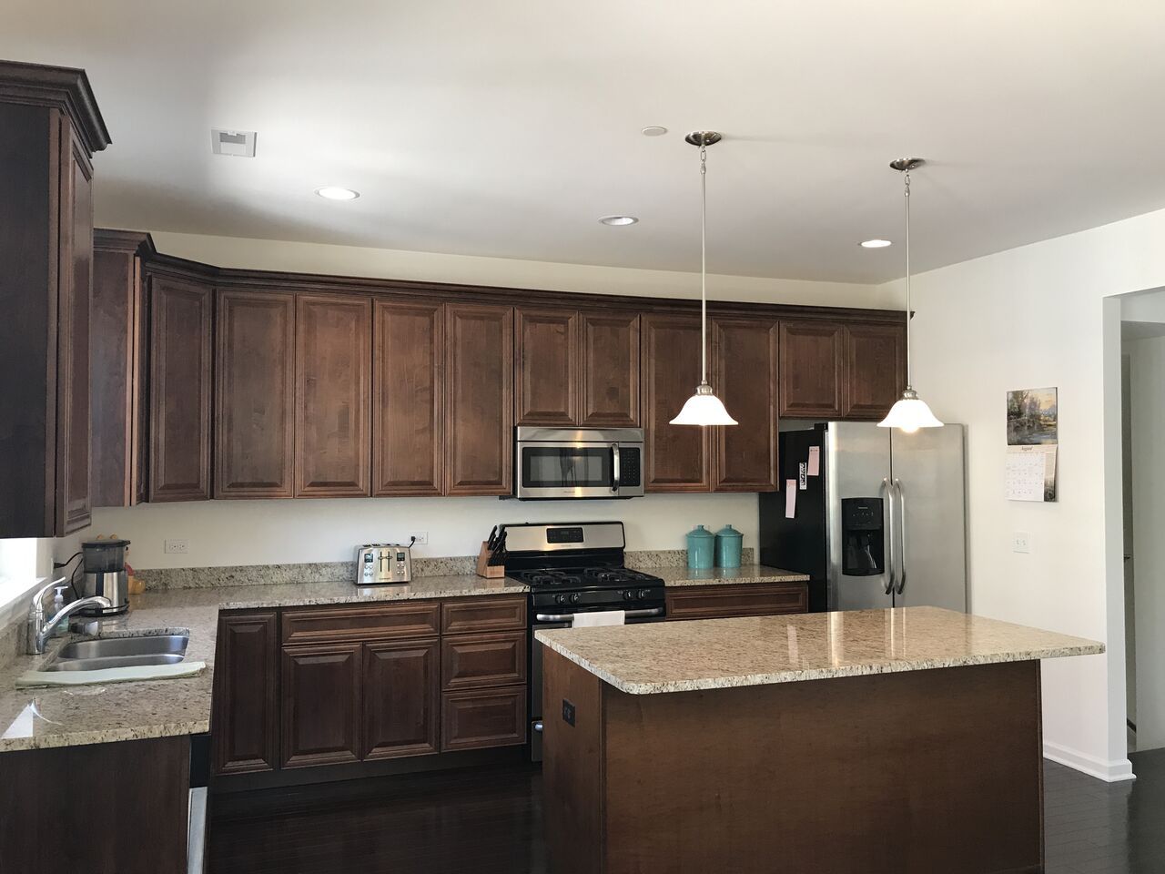 A kitchen with wooden cabinets and granite counter tops