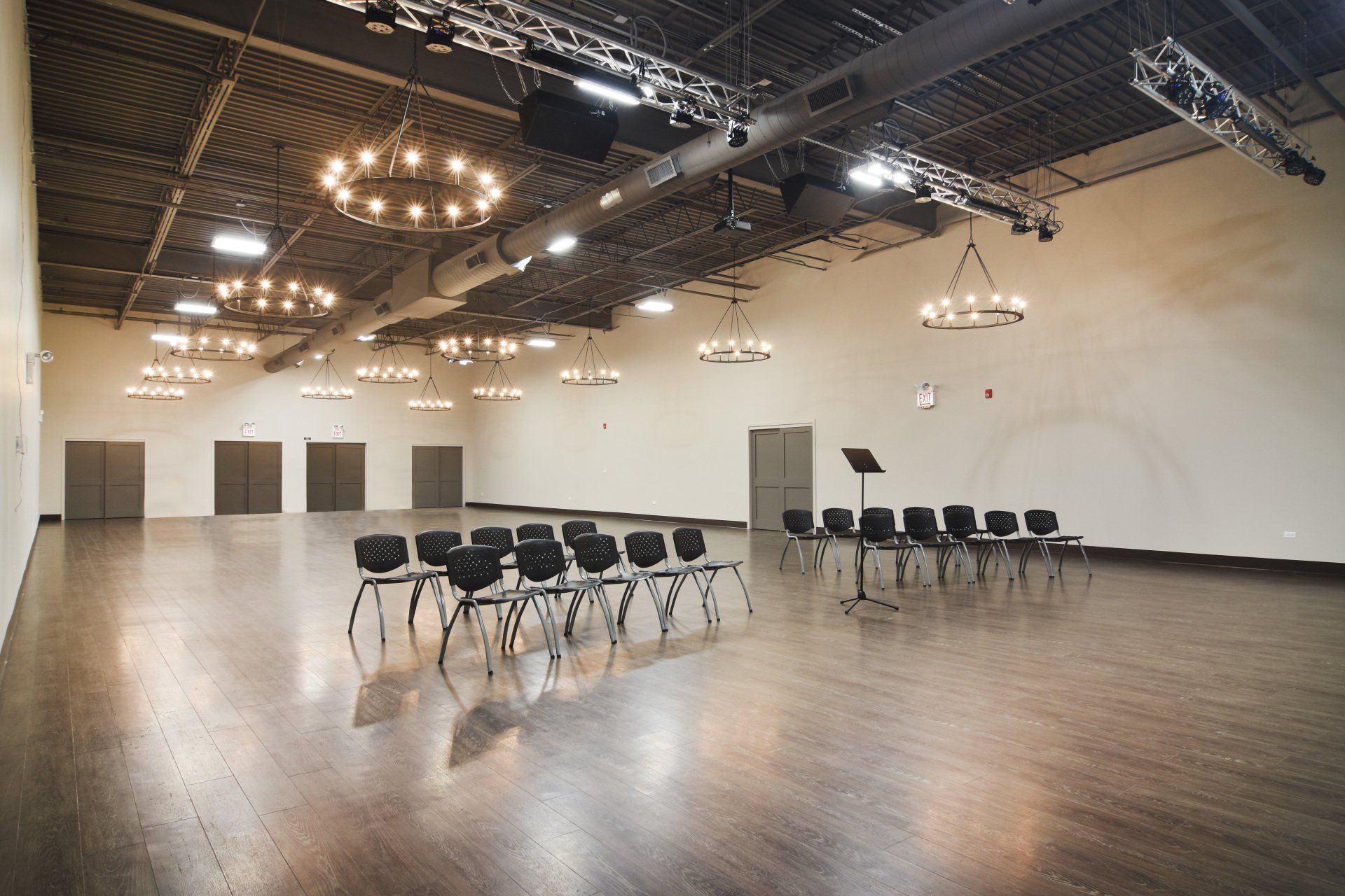 A large empty room with chairs and a piano.