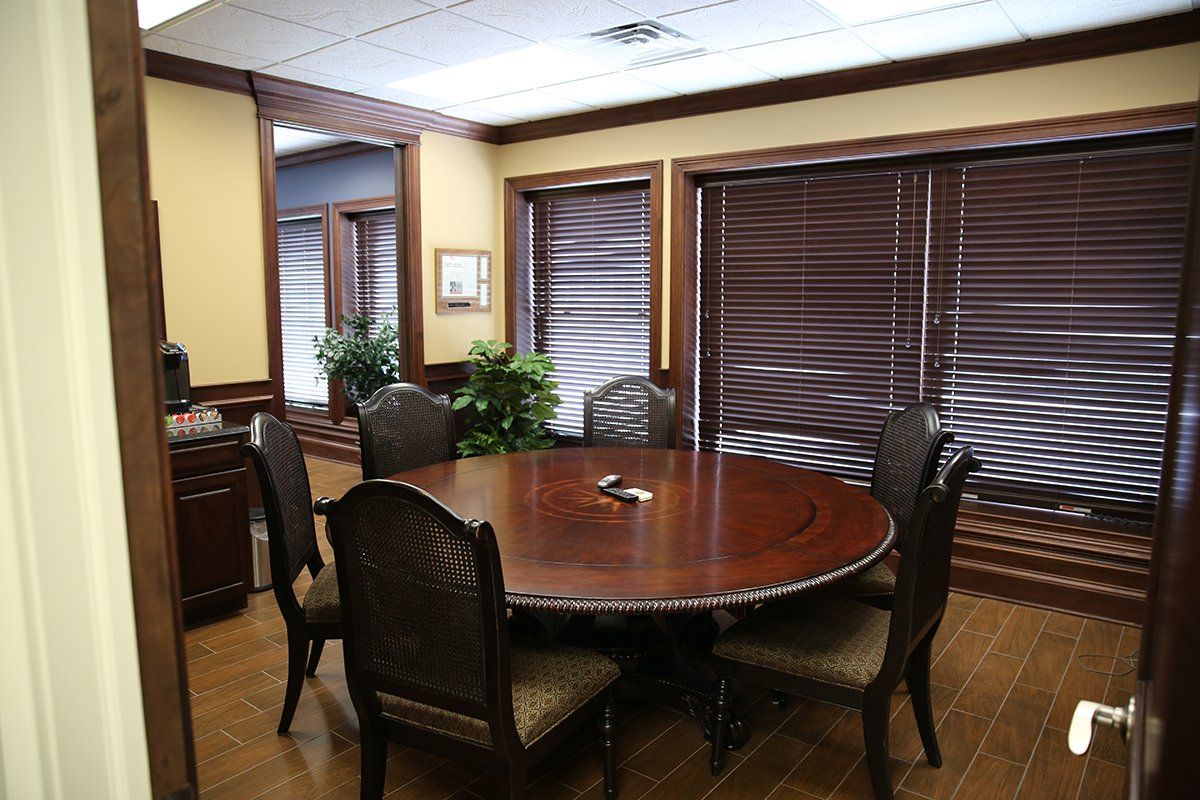 A dining room with a round table and chairs