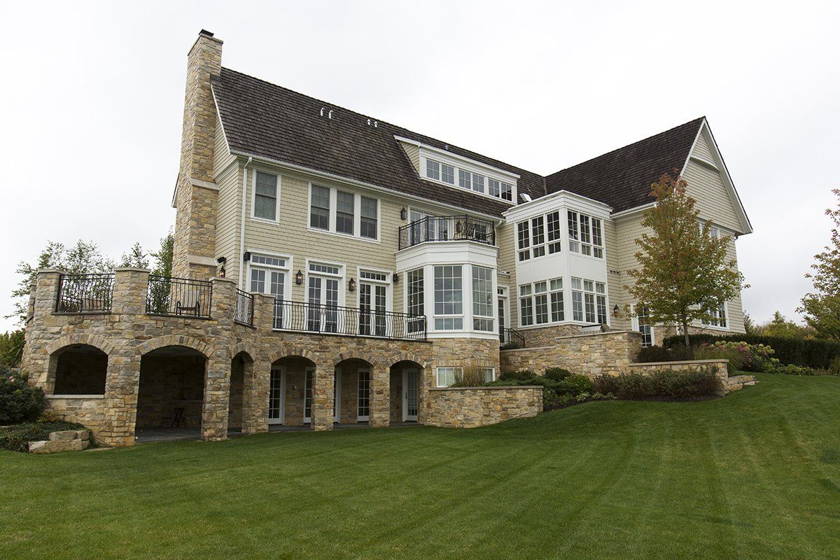 A large house with a large lawn in front of it