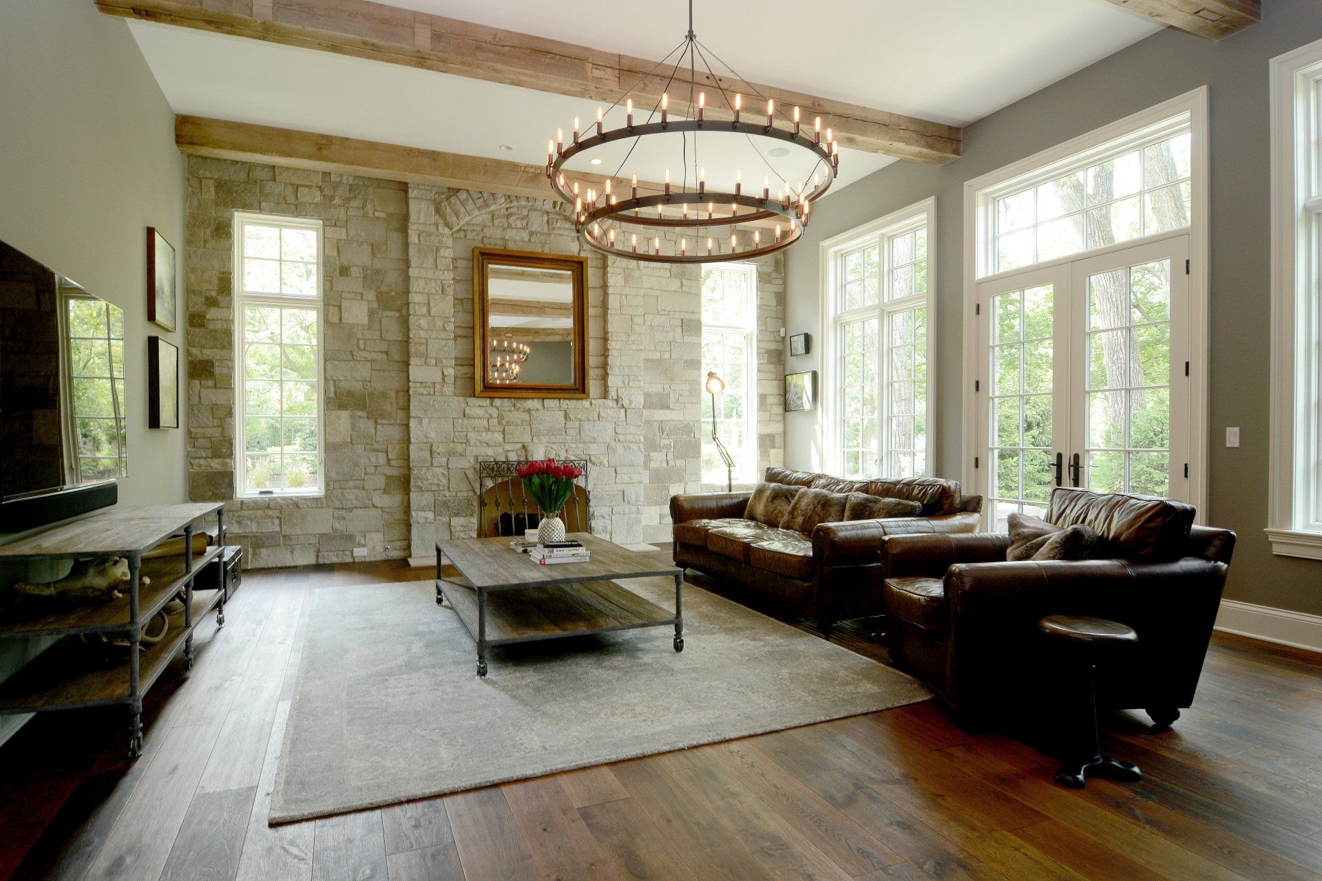 A living room with a couch , chair , coffee table and television.