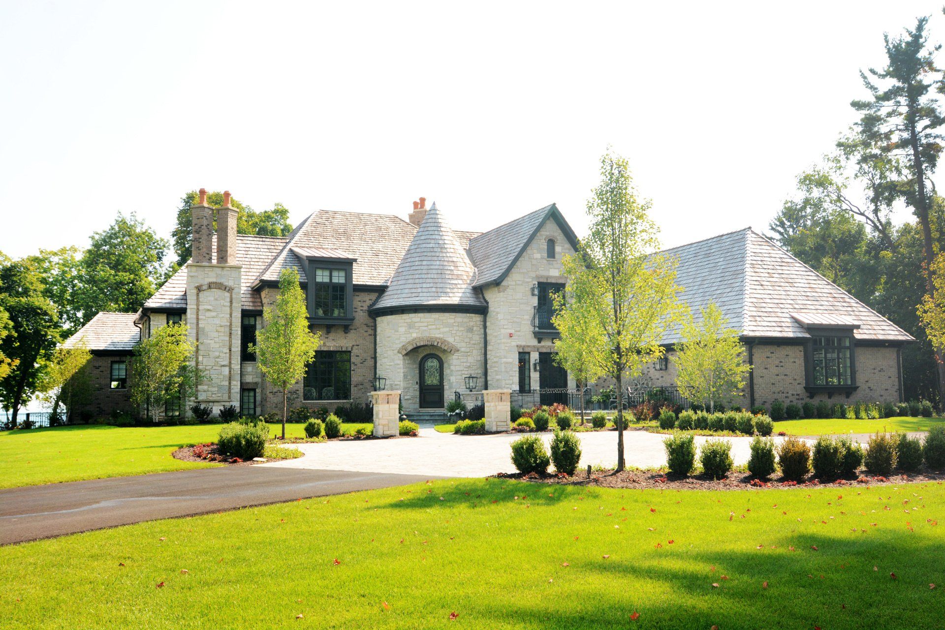 A large house with a lush green lawn in front of it