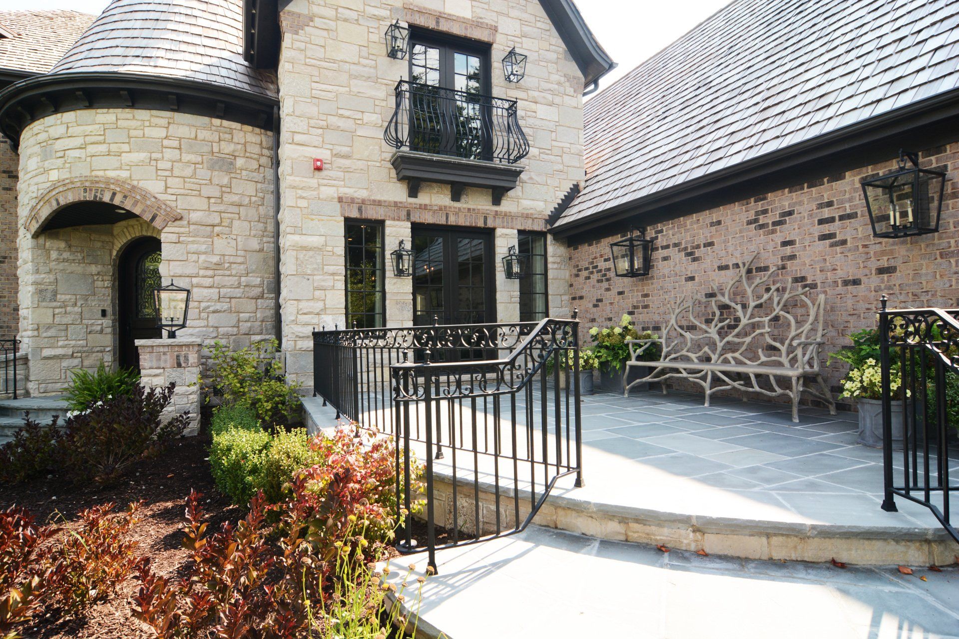 A large brick house with a patio in front of it