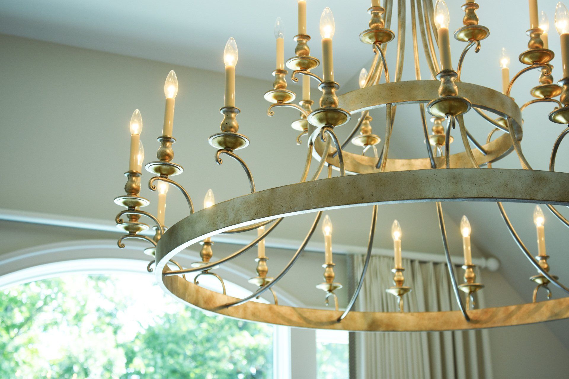 A large chandelier is hanging from the ceiling in a room