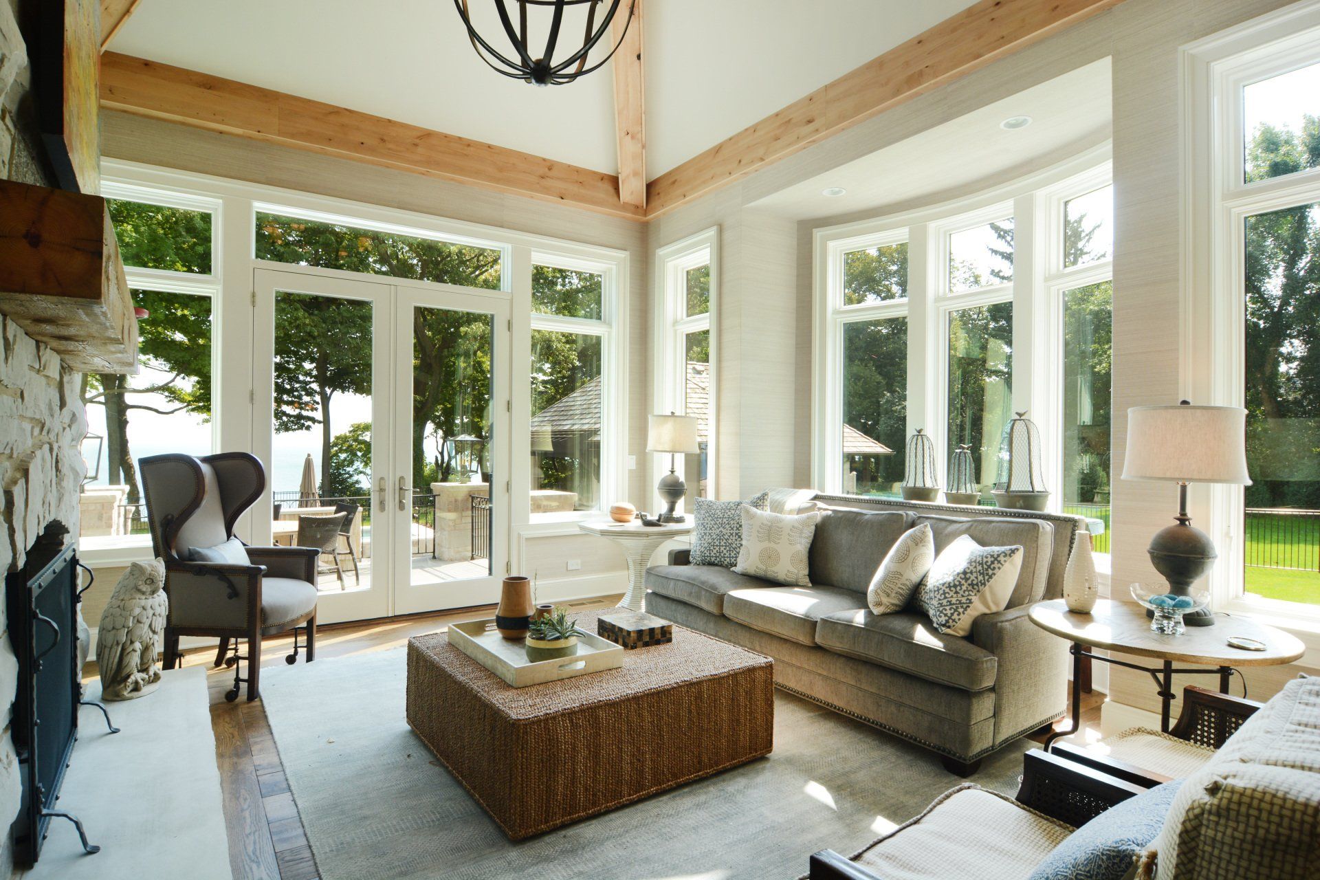 A living room with a lot of windows and furniture