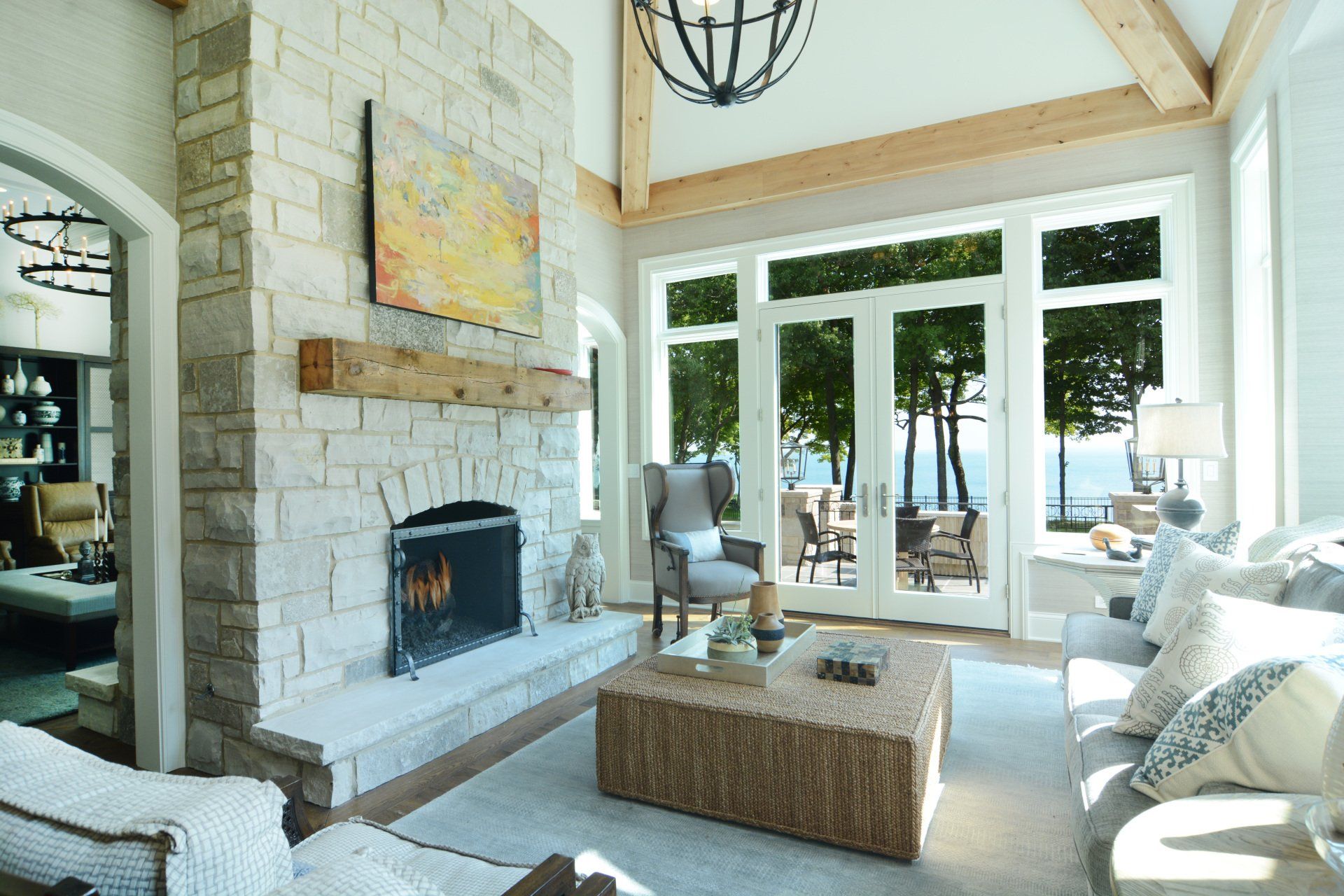 A living room with a fireplace and lots of windows