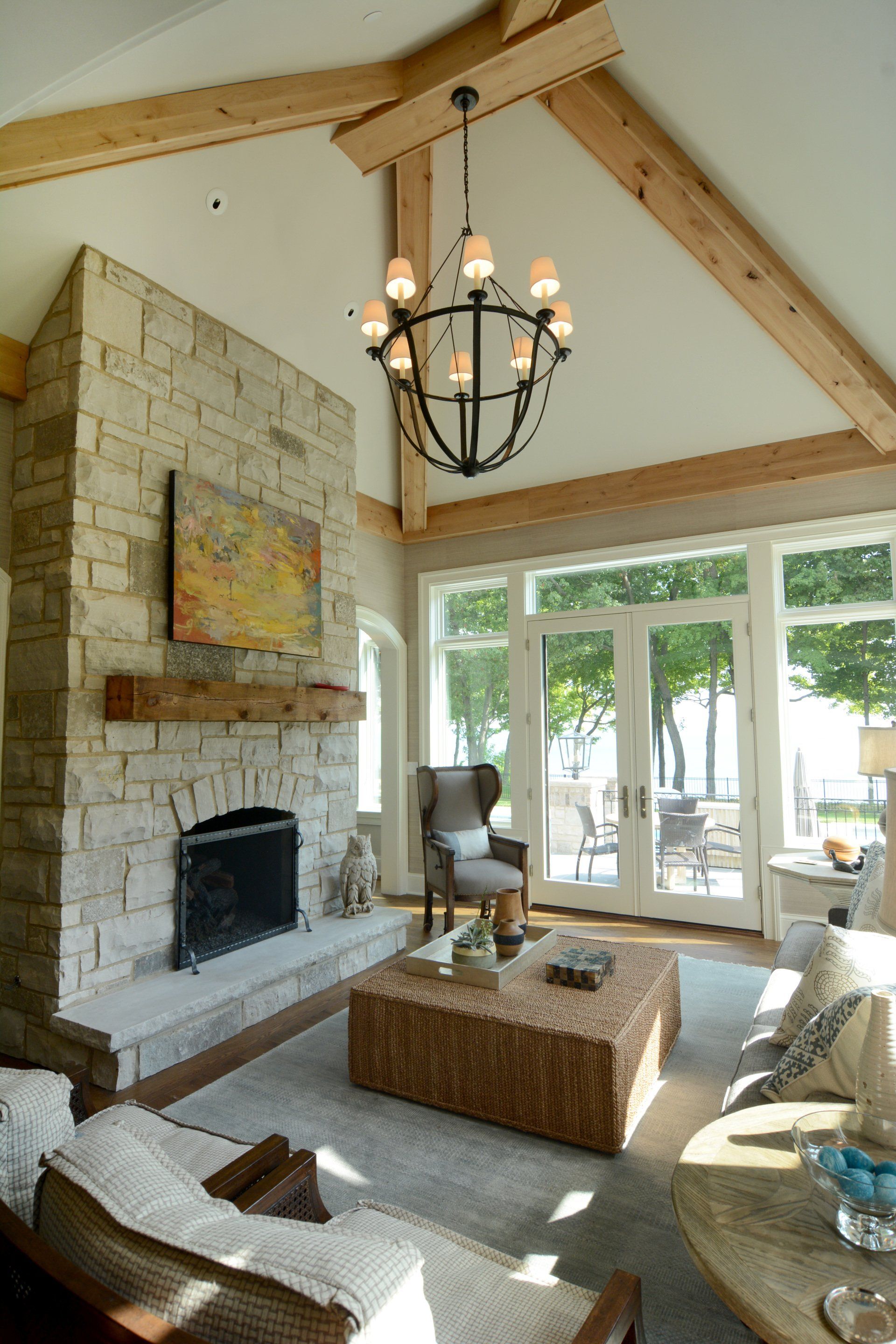 A living room with a fireplace and a chandelier