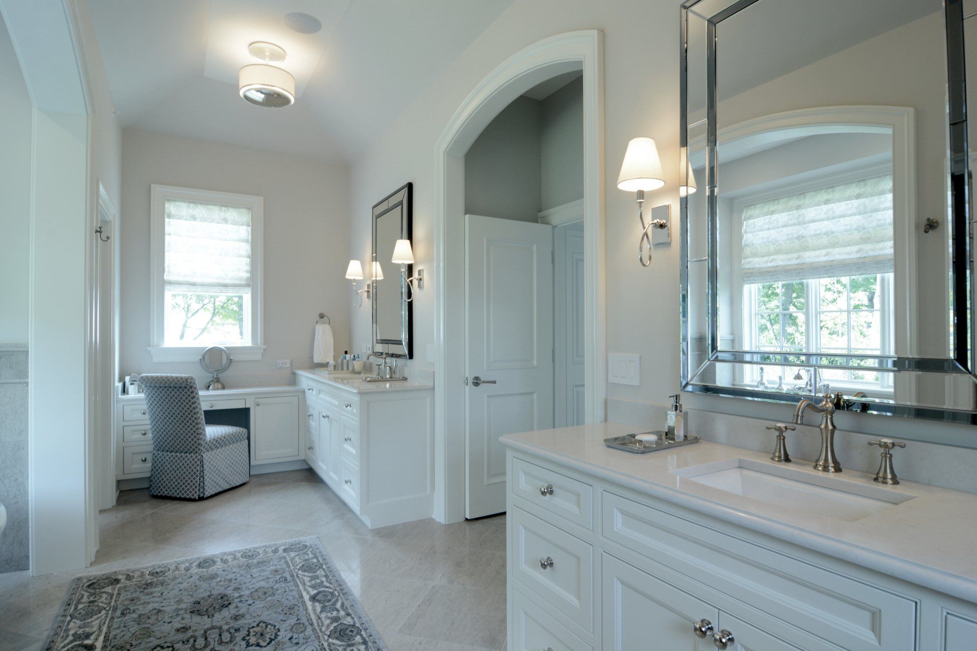 A bathroom with two sinks and a large mirror