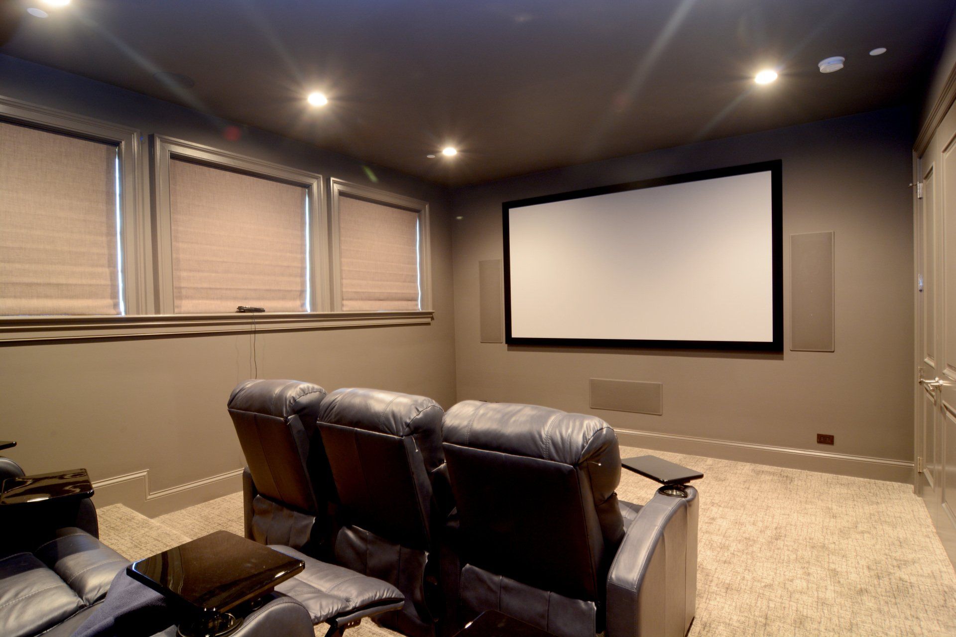 A home theater with a large screen and a couch