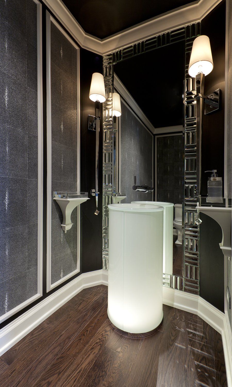 A bathroom with a pedestal sink and a mirror