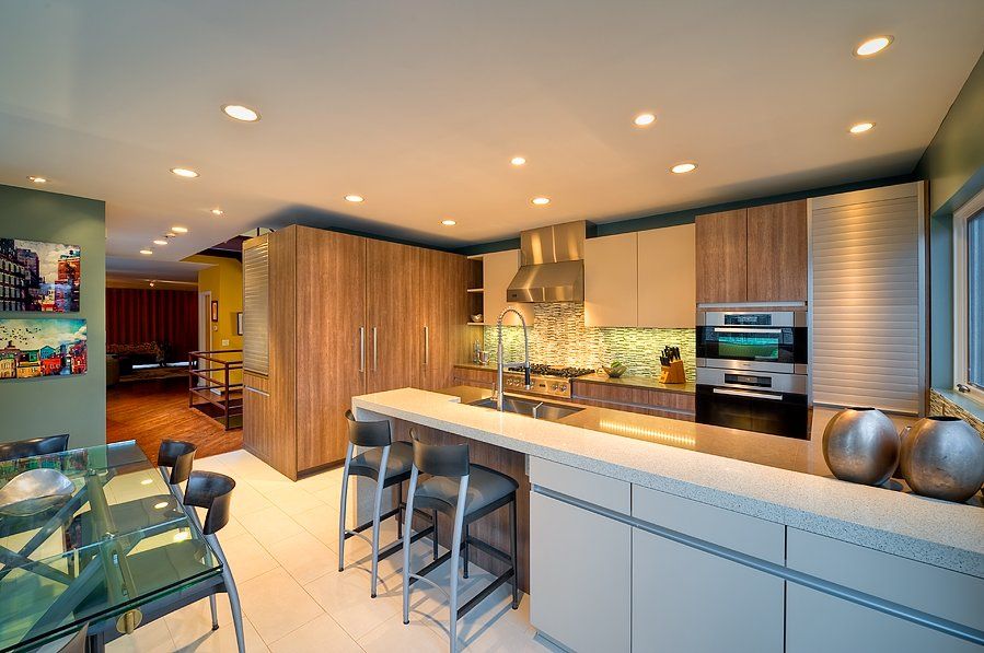A kitchen with a table and chairs in it