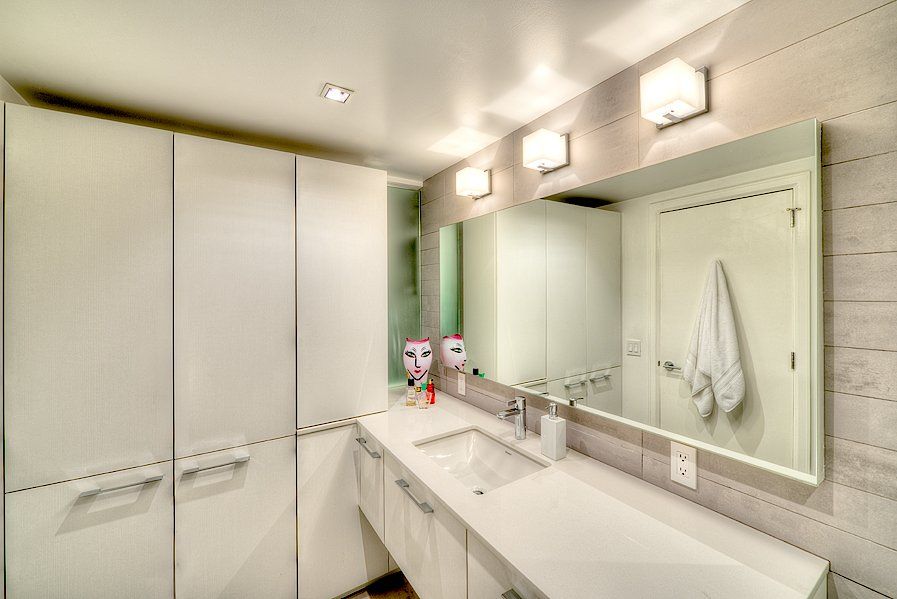A bathroom with two sinks and a large mirror.