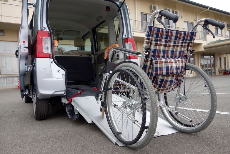 A wheelchair is sitting on a ramp in the back of a van.