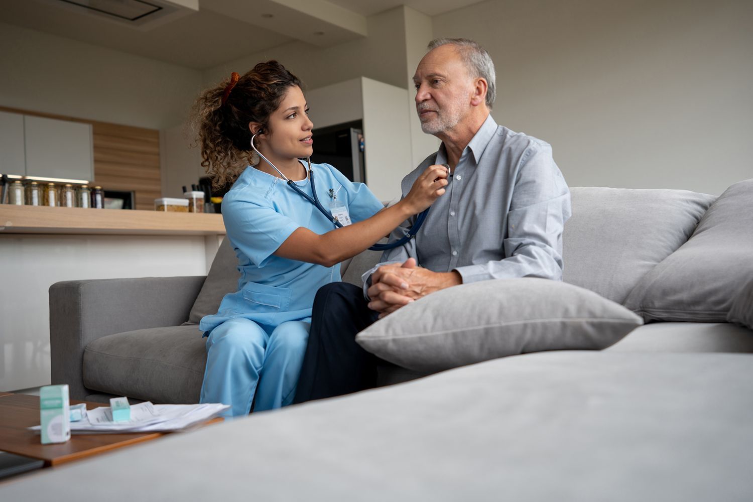 Home caregiver checking a senior man's vitals, showcasing quality home post-op care services.