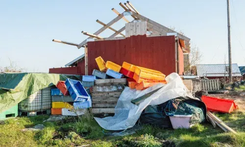 Large pile of sorted plastic crates and waste at an outdoor disposal site.