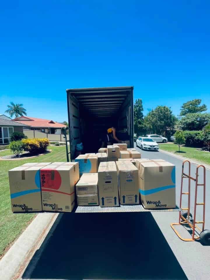 A Truck Filled With Boxes is Parked on the Side of the Road — GNQ Removals–Transport–Storage In Portsmith, QLD