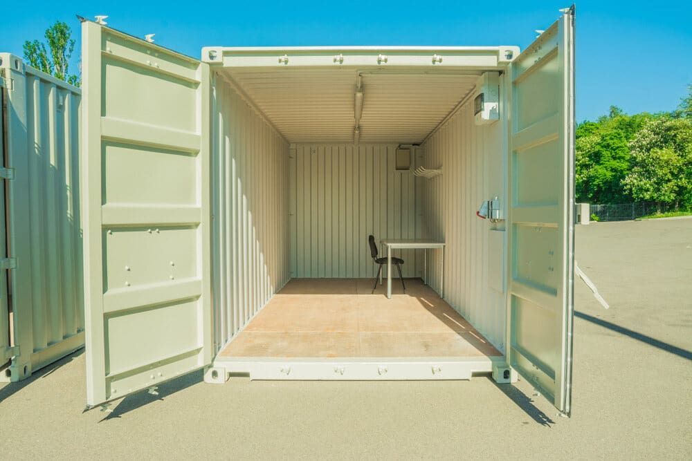 A Shipping Container With Its Doors Open and a Desk Inside of It — GNQ Removals–Transport–Storage In Redlynch, QLD