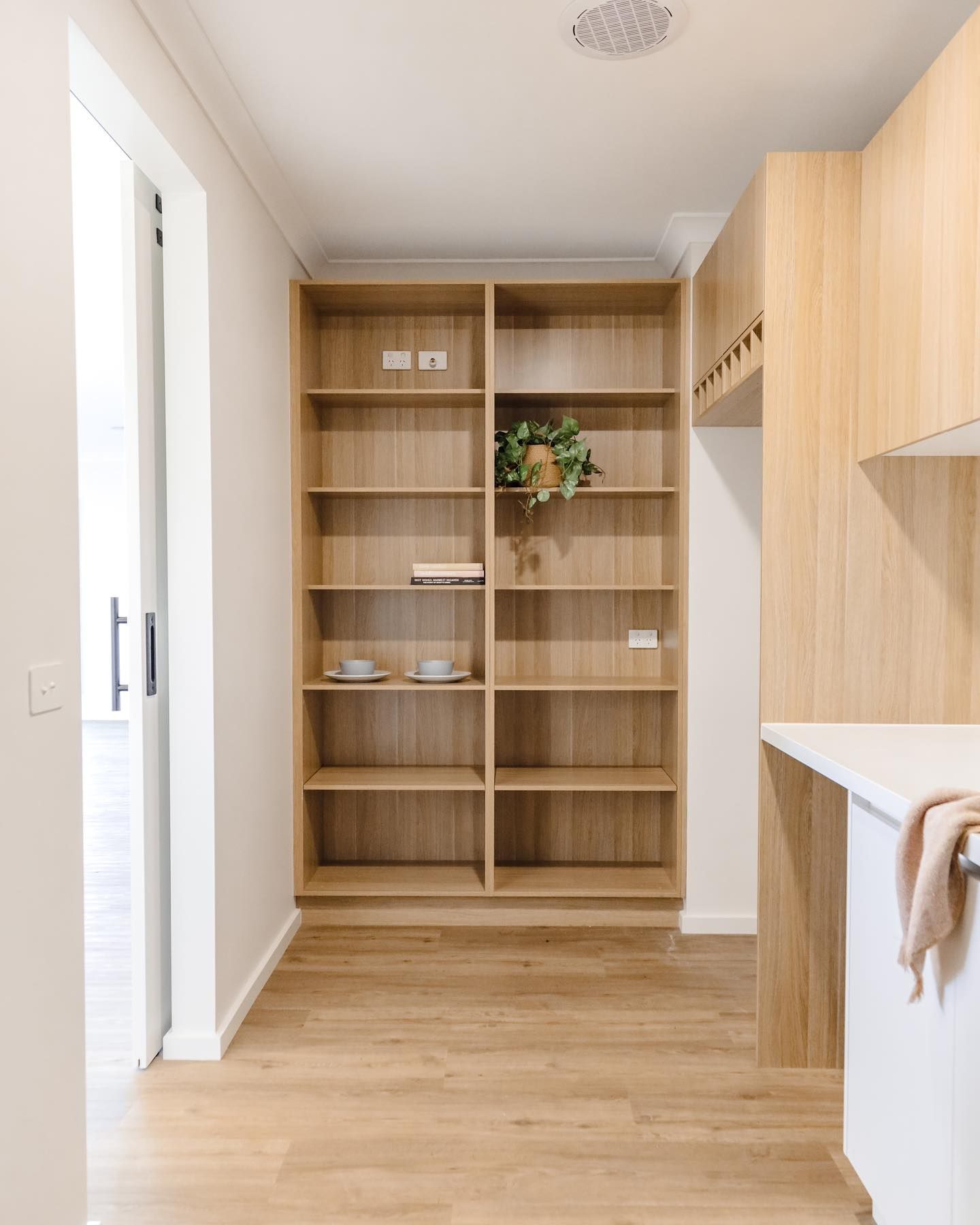 A Kitchen with Wooden Shelves and A White Counter Top — VG Cabinets In Warrnambool, VIC