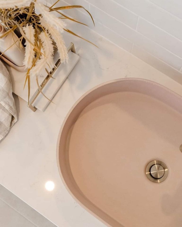 A Pink Sink Is on A White Counter in A Bathroom — VG Cabinets In Warrnambool, VIC