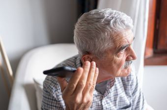 Senior Man Using Smartphone | Appleton, WI | Hearing Clinics of Wisconsin