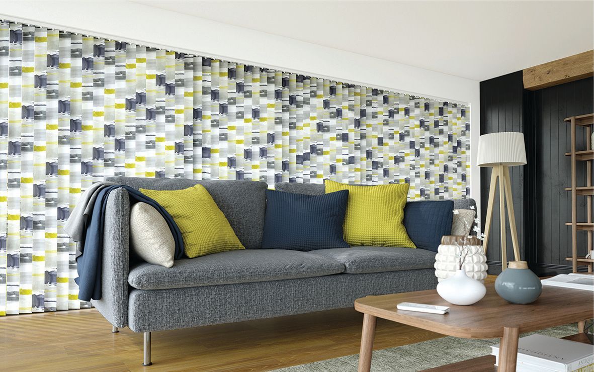 Living room with gray sofa, patterned window blinds, and decorative pillows Wares Blinds, Screens & Awnings In Gladstone Central, QLD
