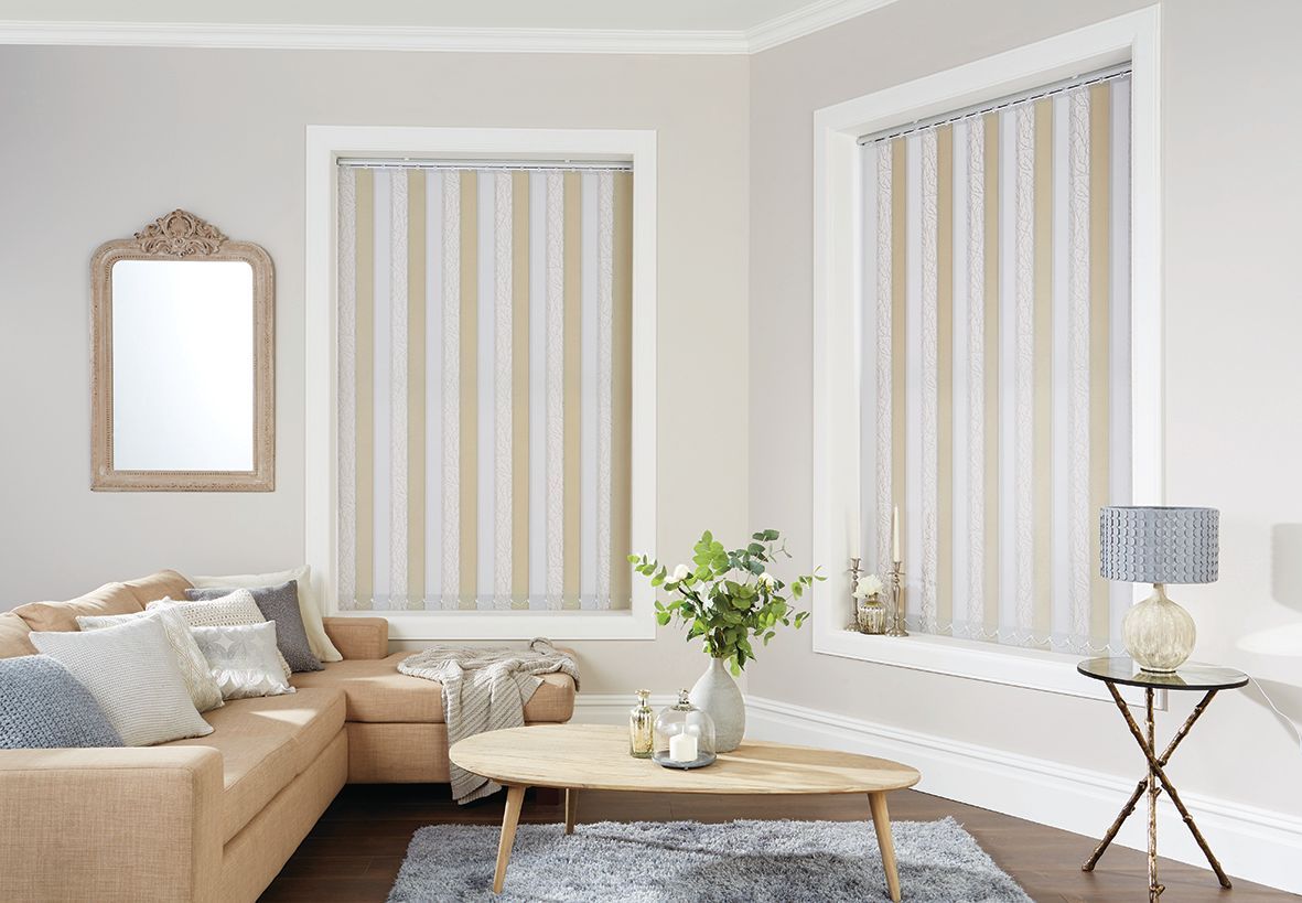 Living room with striped window blinds, couch, coffee table, mirror, lamp, and rug.
