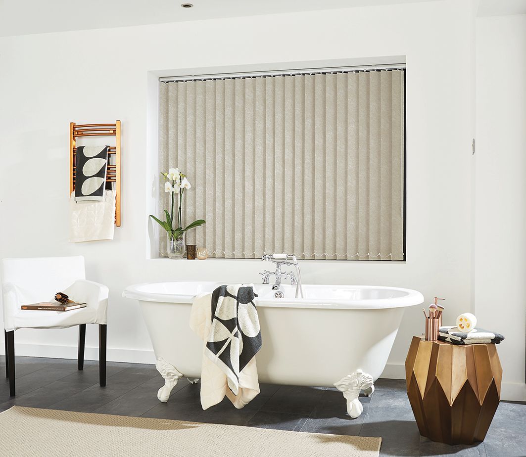 Bathroom with a clawfoot tub under a window with beige blinds, a wooden side table, and a towel rack.