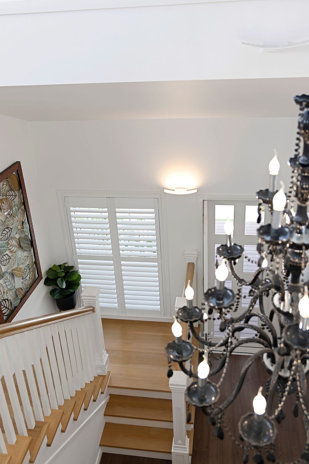 Staircase Interior With Chandelier, Shutters, and Artwork — Wares Blinds, Screens & Awnings In Gladstone Central, QLD