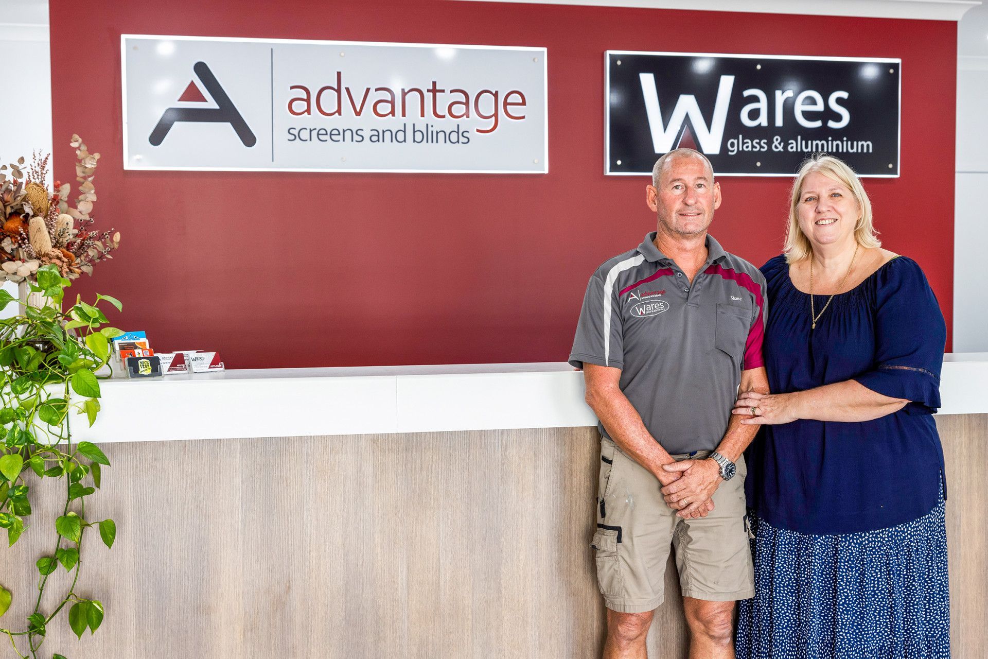 Man and woman stand under signs for