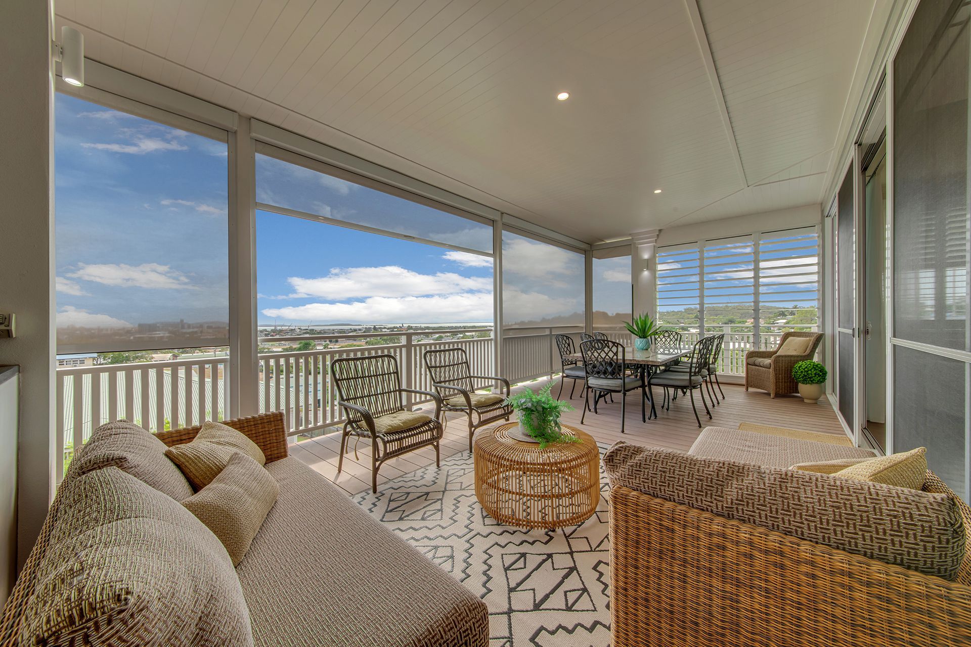 Covered patio with seating, dining area, and scenic view.