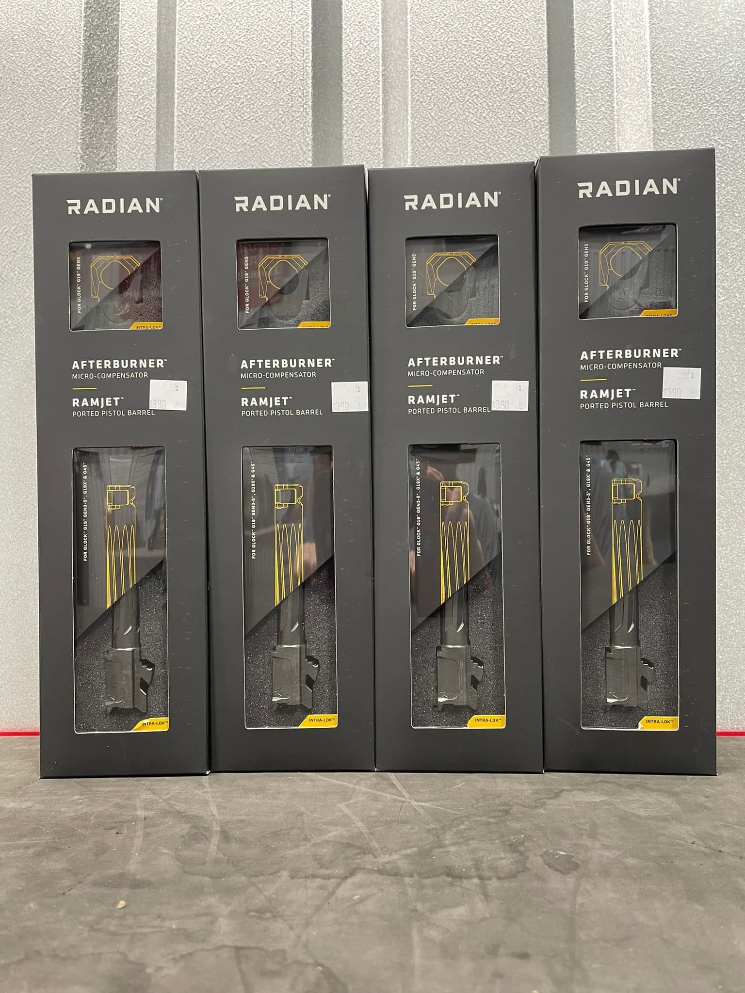 A row of black boxes sitting next to each other on a concrete floor.