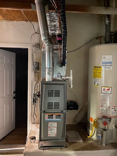 There is a water heater and a furnace in the room.