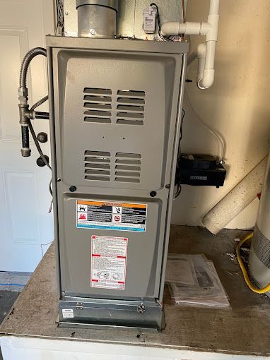 A furnace is sitting on top of a wooden table in a room.