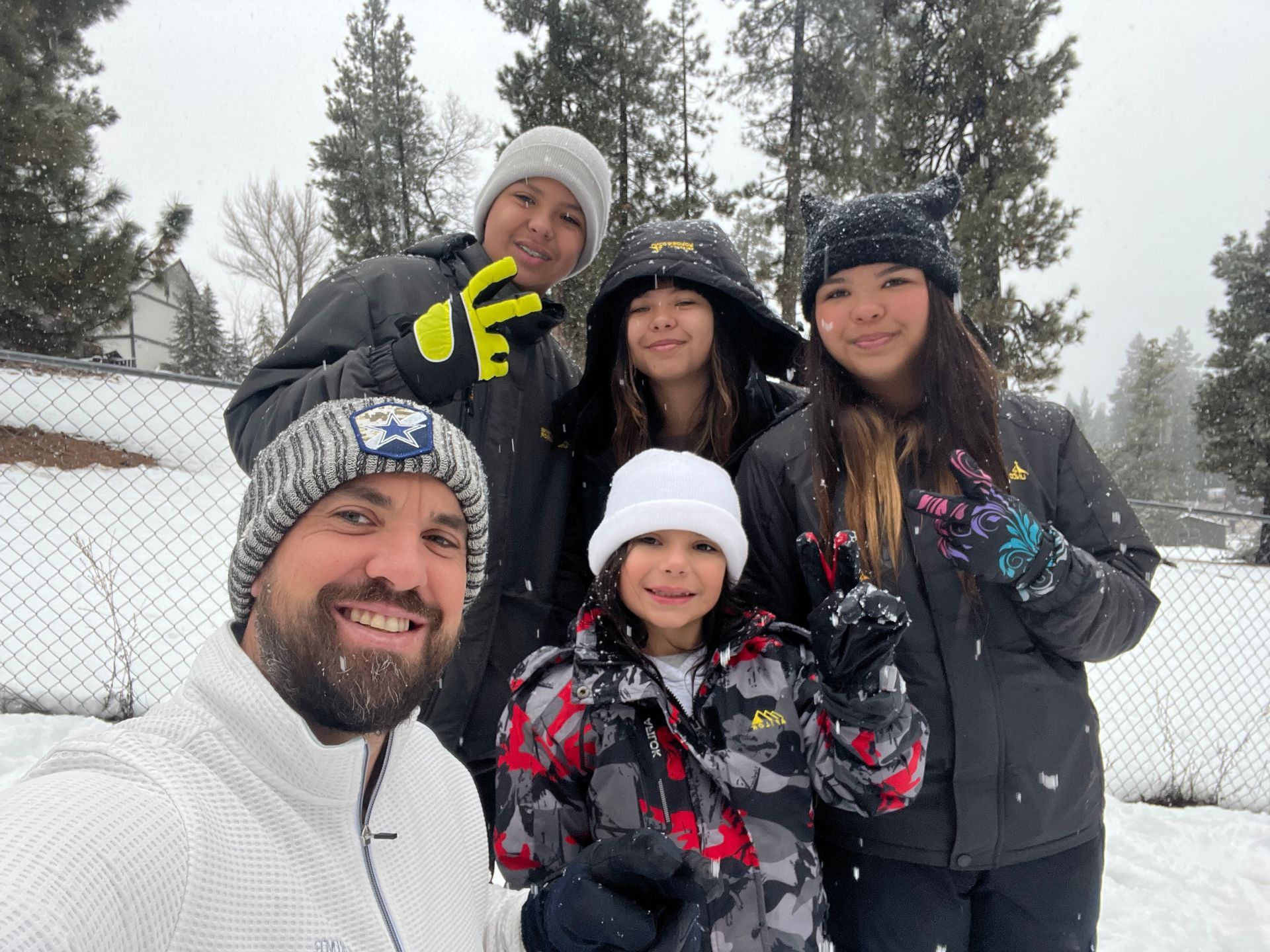 A group of people are posing for a picture in the snow.