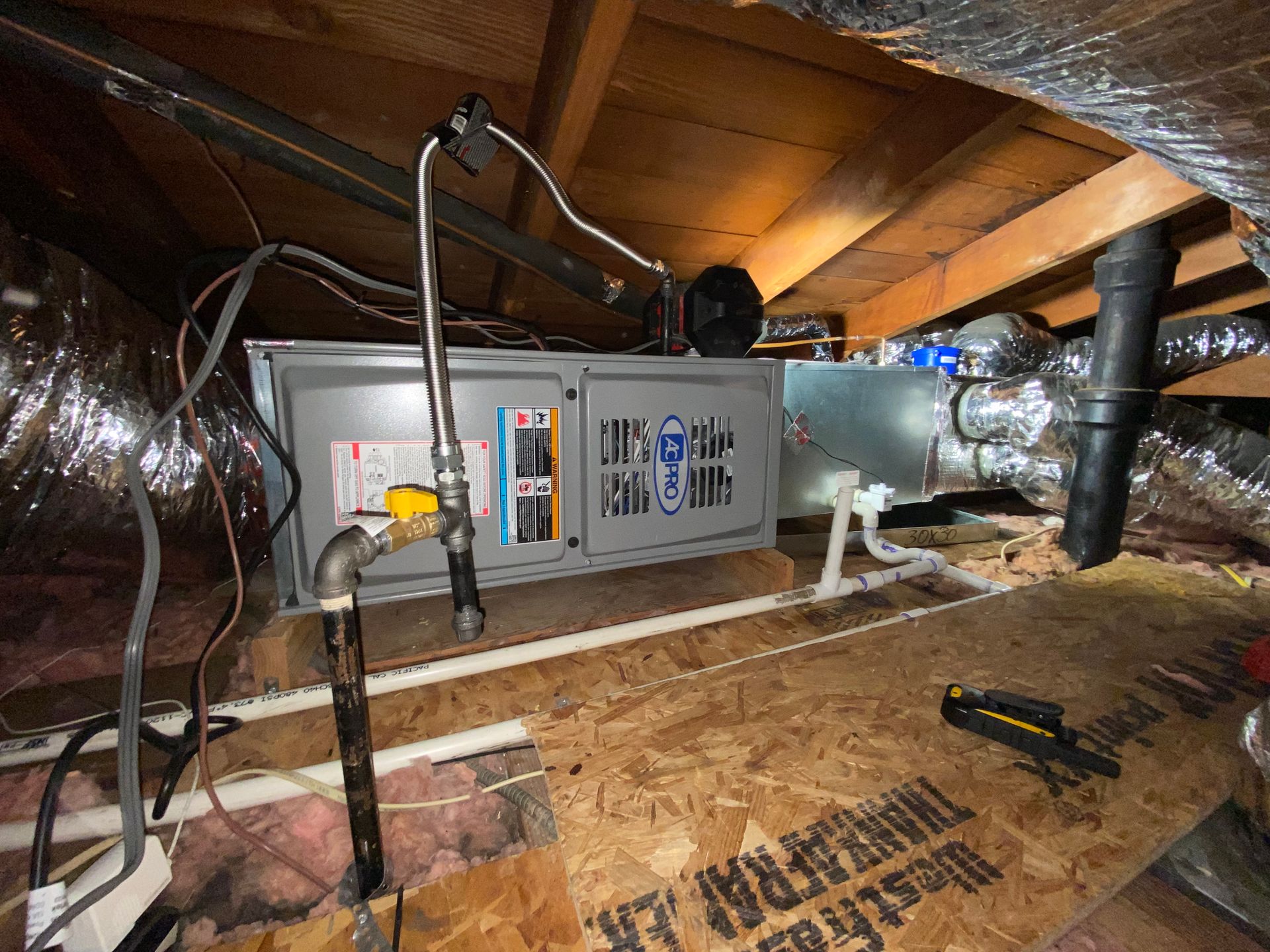 An air conditioner is installed in the attic of a house.