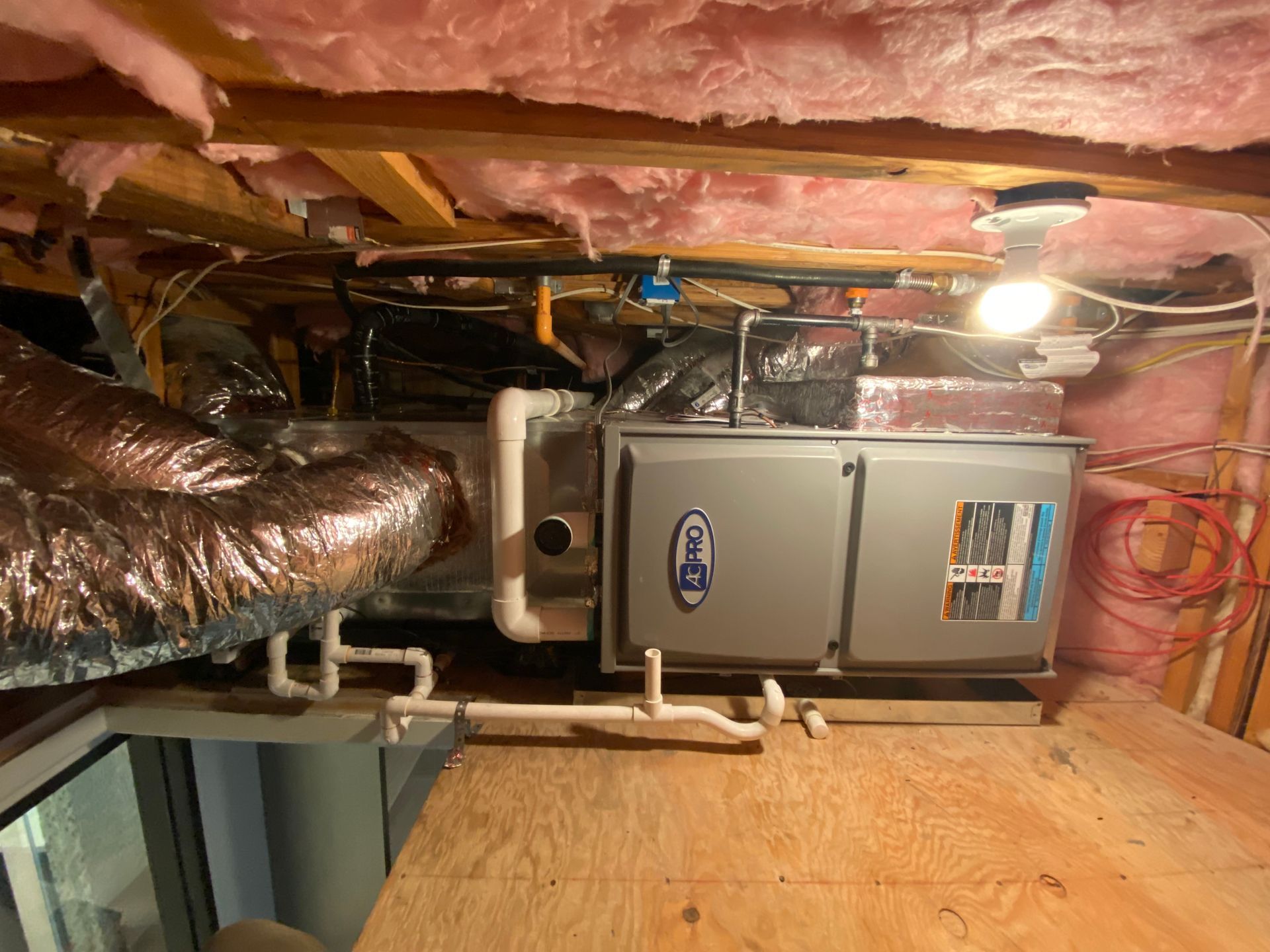 A picture of an air conditioner in a basement.